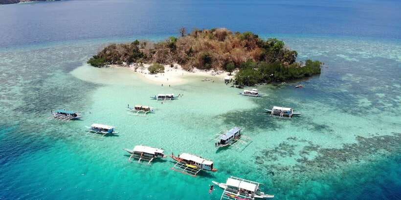 From Coron: Island Hopping Boat Day Trip with Buffet Lunch - A beach buffet with food prepared on the boat